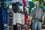 Man inspecting semi trucks at dealership lot 2026 03 24 00 32 09 utc (1)