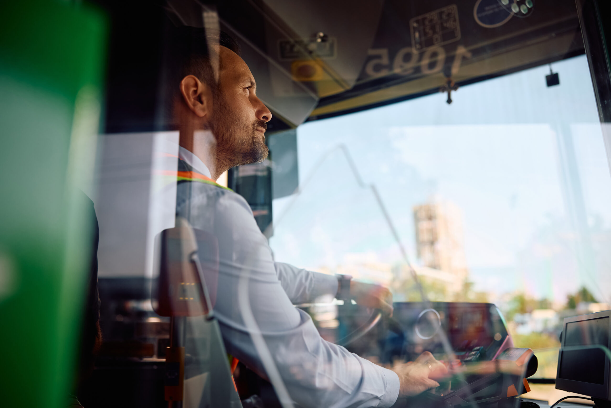 City bus driver opening vehicle doors at the station.